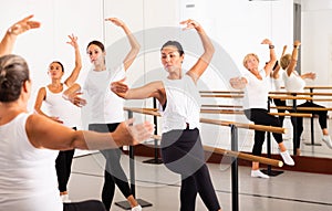 Ballet troupe of different ages in lesson in dance class photo