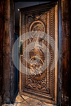 BALLINTOY HARBOUR, NORTHERN IRELAND, DECEMBER 20, 2018: Magnificent carved door with dragons and Dothraki horses, made with wood