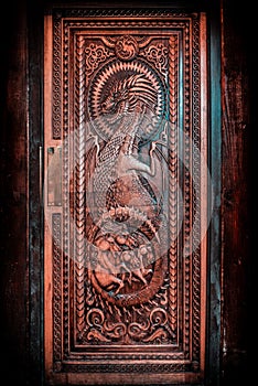 BALLINTOY HARBOUR, NORTHERN IRELAND, DECEMBER 20, 2018: Magnificent carved door with dragons and Dothraki horses, made with wood