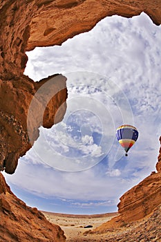 The balloon flies above a picturesque canyon