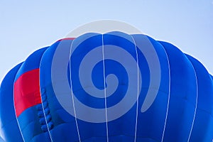 Balloon flying high in the sky. Aerostat close-up. Aeronautic sport. Burning gas. Bright multi-colored hot air balloon. Romantic