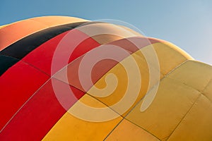 Balloon flying high in the sky. Aerostat close-up. Aeronautic sport. Burning gas. Bright multi-colored hot air balloon. Romantic