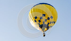 Balloon flying high in the sky. Balloon basket with people. Aeronautic sport. Burning gas. Bright multi-colored balloon. Romantic