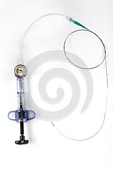 A balloon inflation device used in angioplasty procedure. Mesh metal balloon-expandable stent for endovascular surgery sinning on