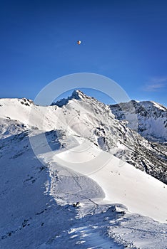 Balloon over the snowy Swinica peak. Tatra mountain