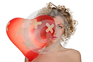 Balloon in shape of heart and hurt woman