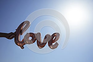 Balloon in the shape of the word love outdoors