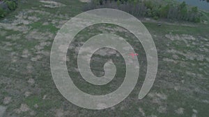 Balloon slowly rises above earth from marked point