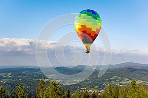 balloon soars beautifully in the air , mountains from flight altitude