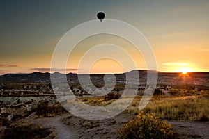 Balloon at sunset flying above Cappadocia