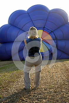 Balloonist inflating balloon