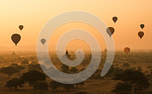 Balloons fly over thousand of temples in sunrise in Bagan, Myanmar