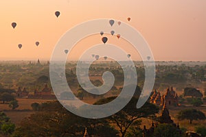 Balloons fly over thousand of temples in sunrise in Bagan, Myanmar