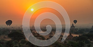 Balloons fly over thousand of temples in sunrise in Bagan, Myanmar