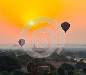 Balloons fly over thousand of temples in sunrise in Bagan, Myanmar