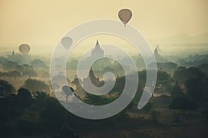 Balloons fly over thousand of temples in sunrise in Bagan, Myanmar