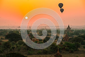 Balloons fly over thousand of temples in sunrise in Bagan, Myanmar