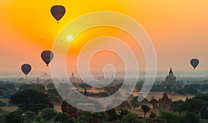 Balloons fly over thousand of temples in sunrise in Bagan, Myanmar