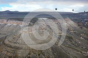 Balloons fly over the valleys in Cappadocia