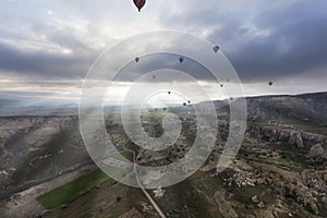 Balloons fly over the valleys in Cappadocia