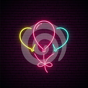 Balloons neon sign. Three glowing balloons design for celebration and decoration isolated on brick wall background.