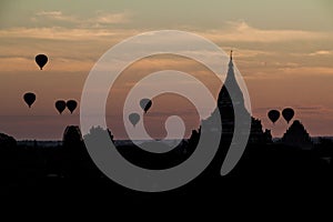 Balloons over Bagan and the skyline of its temples, Myanmar. Sulamani temple and Shwesandaw pagod