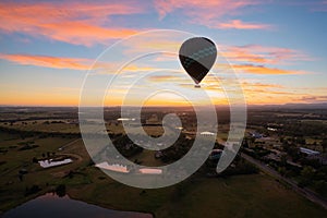 Balloons over vineyards in Pokolbin wine region at sunrise, Hunter Valley, NSW, Australia