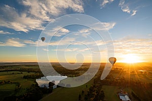 Balloons over vineyards in Pokolbin wine region at sunrise, Hunter Valley, NSW, Australia