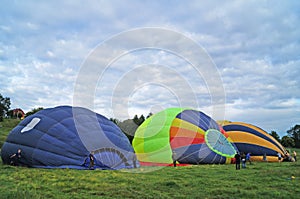Balloons of red, blue, yellow, light green and orange inflate