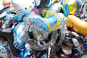 Balloons of various shapes of toys filled with helium.