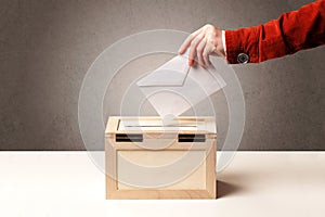 Ballot box with person casting vote