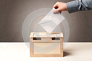 Ballot box with person casting vote