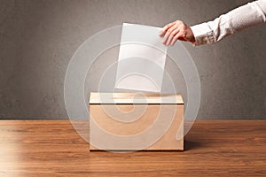 Ballot box with person casting vote