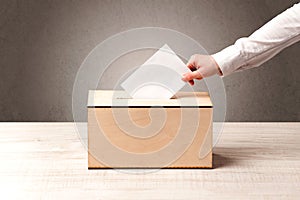 Ballot box with person casting vote