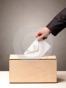 Ballot box with person casting vote