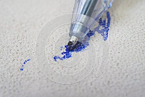 Ballpoint pen tip, scribbling on a white leather sofa, or car seats.