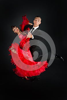 Ballrom dance couple in a dance pose isolated on black background