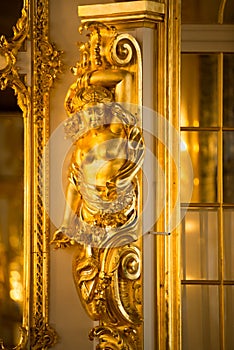 Golden statue in ballroom of roccoco palace Catherine Palace,  located in the town of Tsarskoye Selo or Pushkin St. Petersburg photo