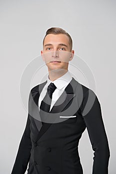 Ballroom dancer in stylish tuxedo. Man in elegant suit with tie. Groom dressed for wedding or holiday celebration. Dress code for