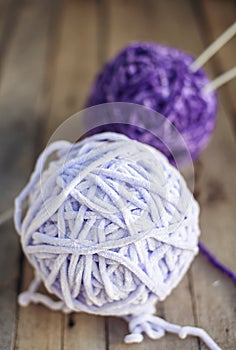 Balls of beautiful soft yarn on wooden background