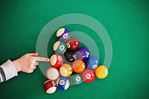 Balls on a billiard table. child playing billiards