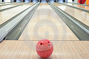 Balls on bowling alley against ten pins