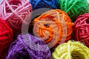 Balls of colored thick thread as an abstract background for variety.
