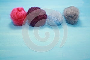 Balls of colored wool for making beads