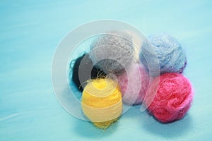 Balls of colored wool for making beads
