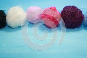 Balls of colored wool for making beads