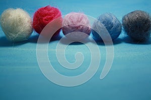 Balls of colored wool for making beads