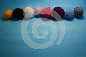 Balls of colored wool for making beads