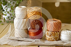 Balls of cotton threads in orange and beige