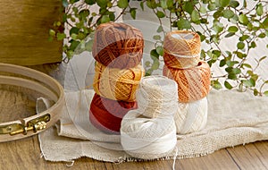 Balls of cotton threads in orange and beige color